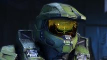 Halo battle royale: Master Chief, a man wearing heavy worn dark-green mech armor stares to the side, his helmet's shining golden visor showing a dark reflection