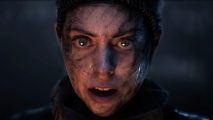 Hellblade sale: A woman with dirt covering her pale face stares ahead surprised, her mouth open and blue eyes wide