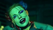 Suicide Squad Rocksteady new studio: Harley Quinn, a woman with blonde hair dipped on either side in blue and red, smiles with her mouth open and head cocked to the right side
