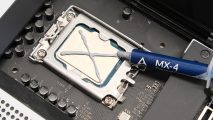 An 'x' is drawn on the CPU with thermal paste for a gaming PC