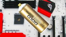 A can of gold spray paint on top of a recently painted motherboard