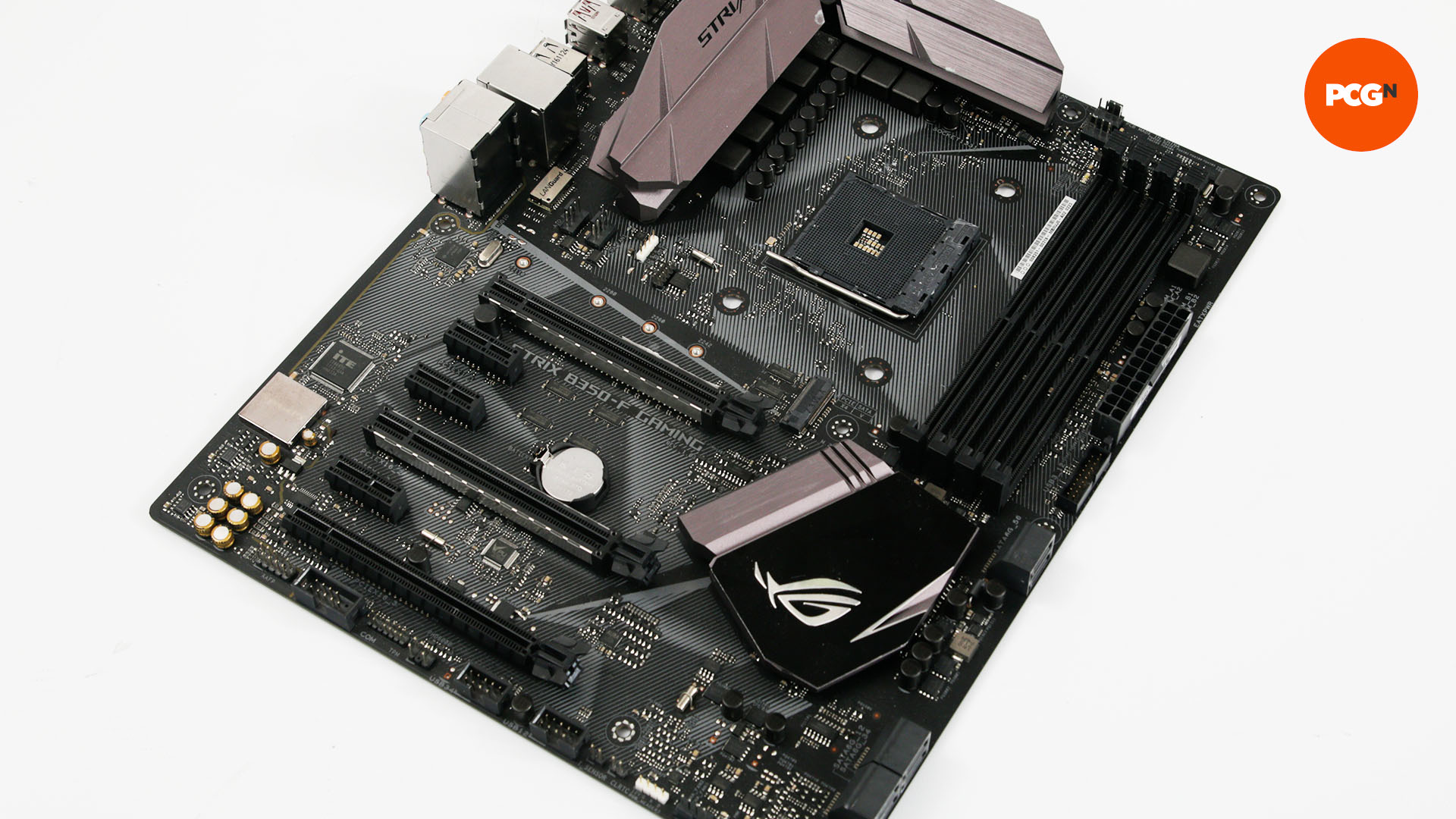 A black motherboard sitting on a white table