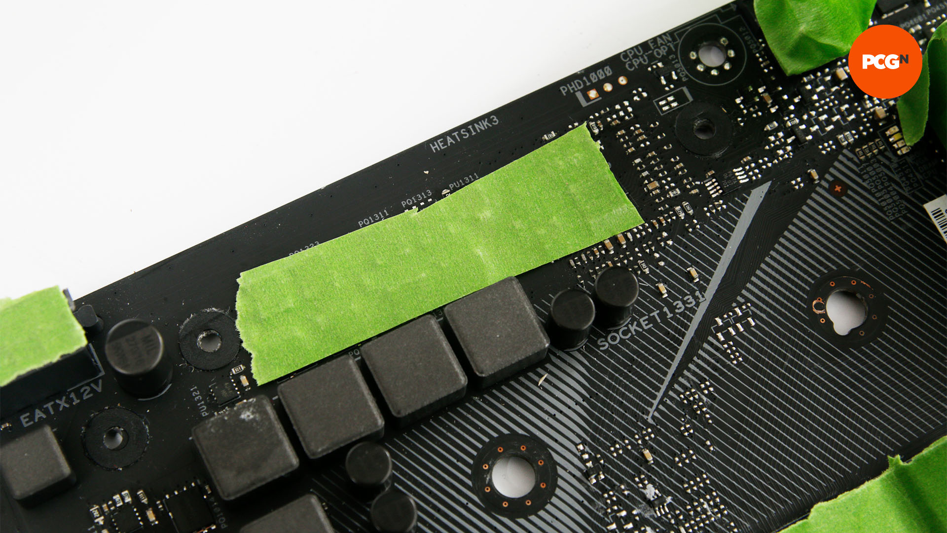 The heatsink contacts are masked with frog tape so that the motherboard painting can be done without damaging the contacts