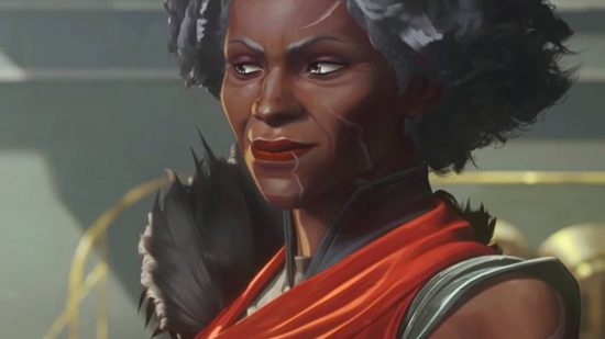 A black woman with scars on her face with short gray hair wearing a red cloak smirks