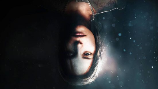 2021's weirdest horror game is getting a movie: A young woman pictured upside down looking into the camera on a black background, which fades to a deep underwater blue