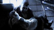 This War of Mine free weekend - a man holds a young child in his arms in a dark room, light flooding through a window behind them.