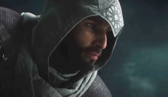 Assassin's Creed Mirage just became the hardest open-world game ever: A bearded Middle Eastern man wearing a hooded cloak with a silver plate on it looking off to the right