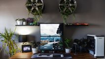 A PC gaming setup full of car wheels and plants
