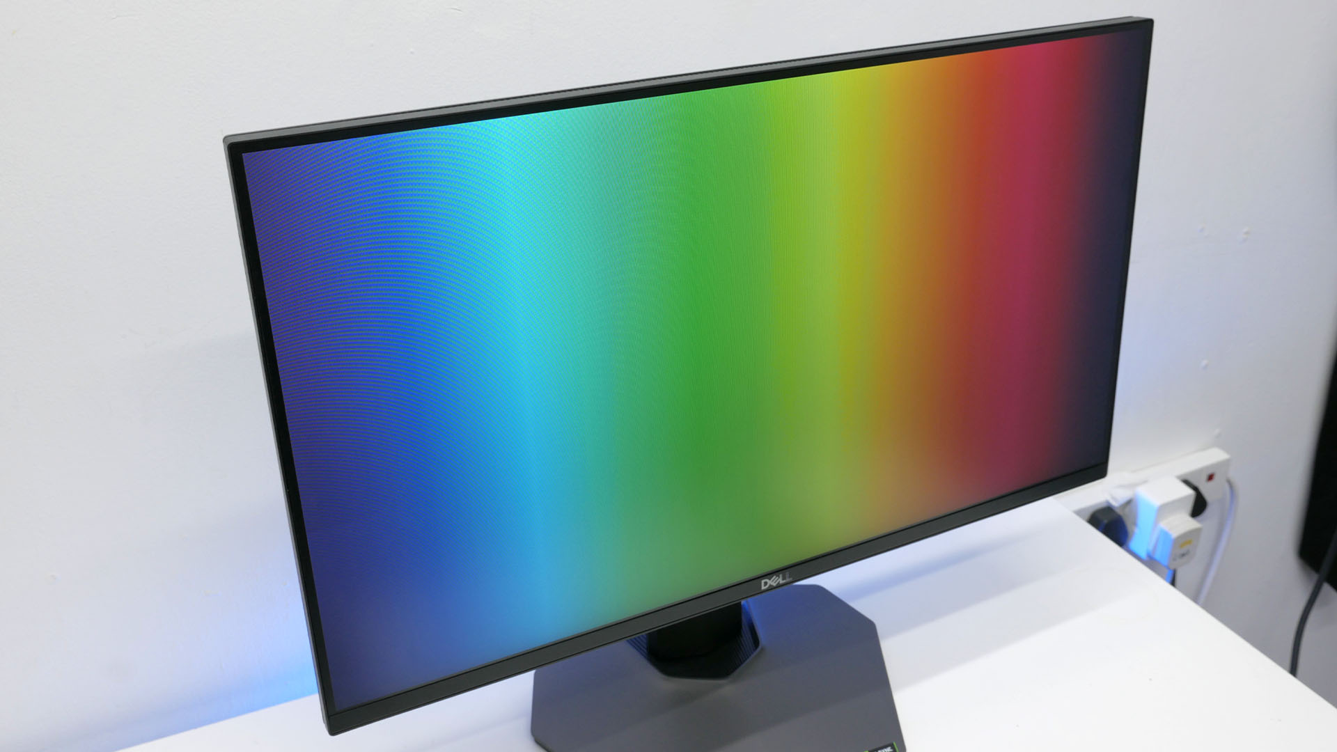 Dell G2524H review image showing the monito with a rainbow gradient on it.