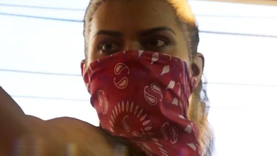 GTA 6 protagonist Lucia comes to GTA 5 - A yong woman wearing a red bandana across her nose and mouth.