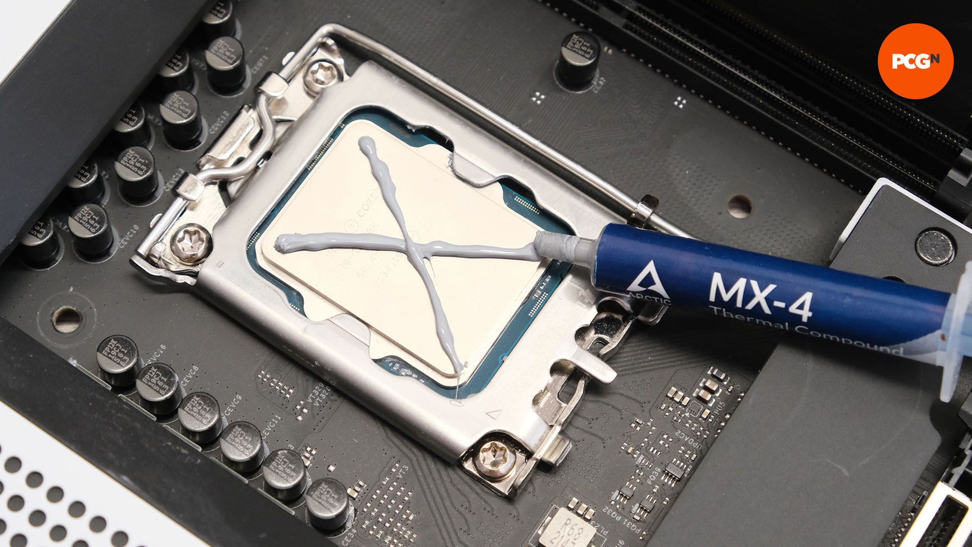 An X is drawn in thermal paste on the CPU sitting in the socket on the motherboard