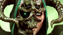 Last Epoch teams up with David Harbour - An Acolyte wearing a green hood with a broken skull mask and large, curved horns.