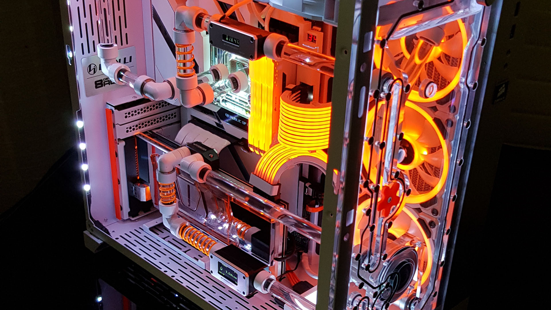 A close up of the internals of the star wars gaming PC, which features oange cables, RGB, and water-cooling