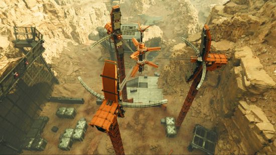 Der First Descendat Vulgus Recon Recon Outpost – Eine Reihe großer orangefarbener Strukturen in einem felsigen Tal.