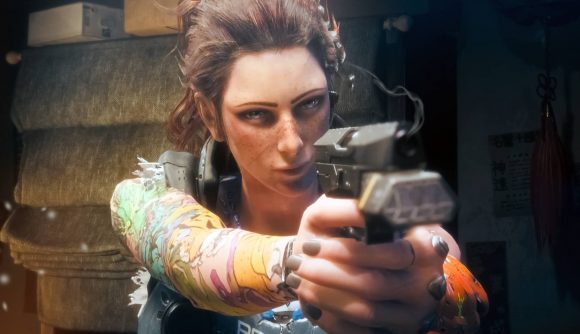 2023's most underrated action game gets much-needed boss overhaul: A woman with brown hair tied in a ponytail and tattoos on her arms raises a gun to the camera