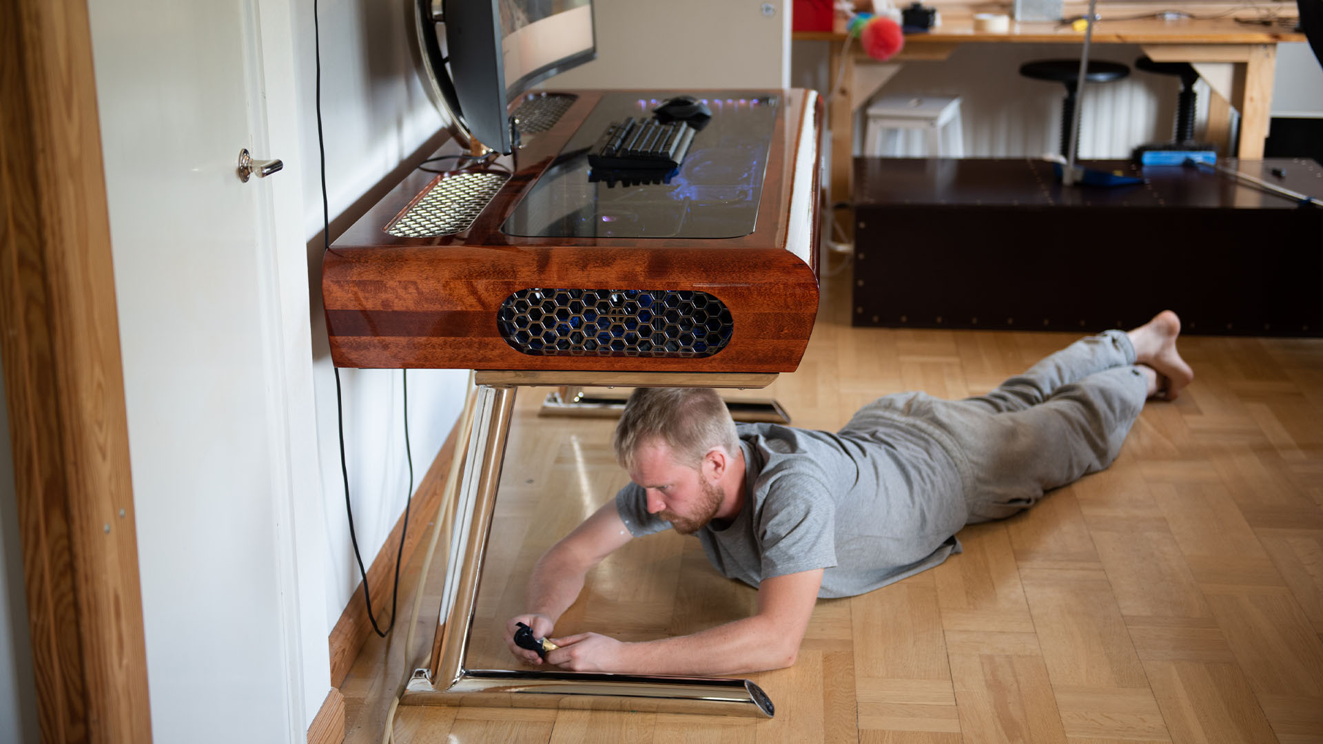 A friend works on the legs of the wooden desk PC