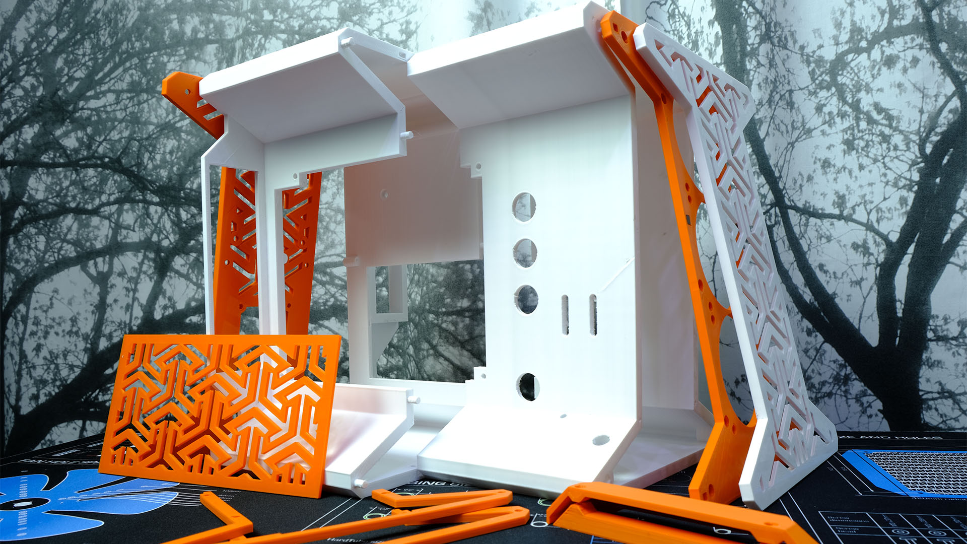 All of the 3D printed parts for the white and orange PC case
