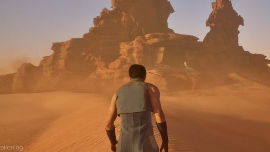 Dune awakening trailer graphics: a man in lightweight clothing standing in front of a very large structure in a desert