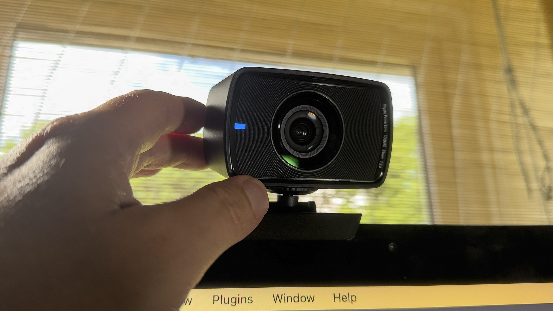 Elgao Facecam review image showing a human hand adjusting the camera.