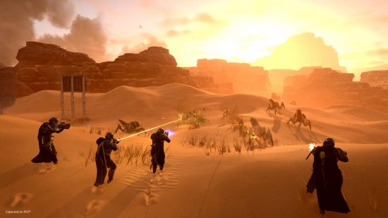 Helldivers 2 - four helldivers holding guns walking across a desert towards a group of eneimes