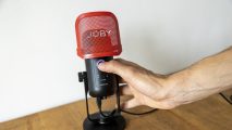 Joby Wavo Pod review image showing the microphone in someone's hand.