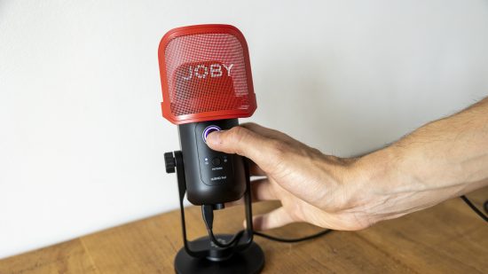 Joby Wavo Pod review image showing the microphone in someone's hand.