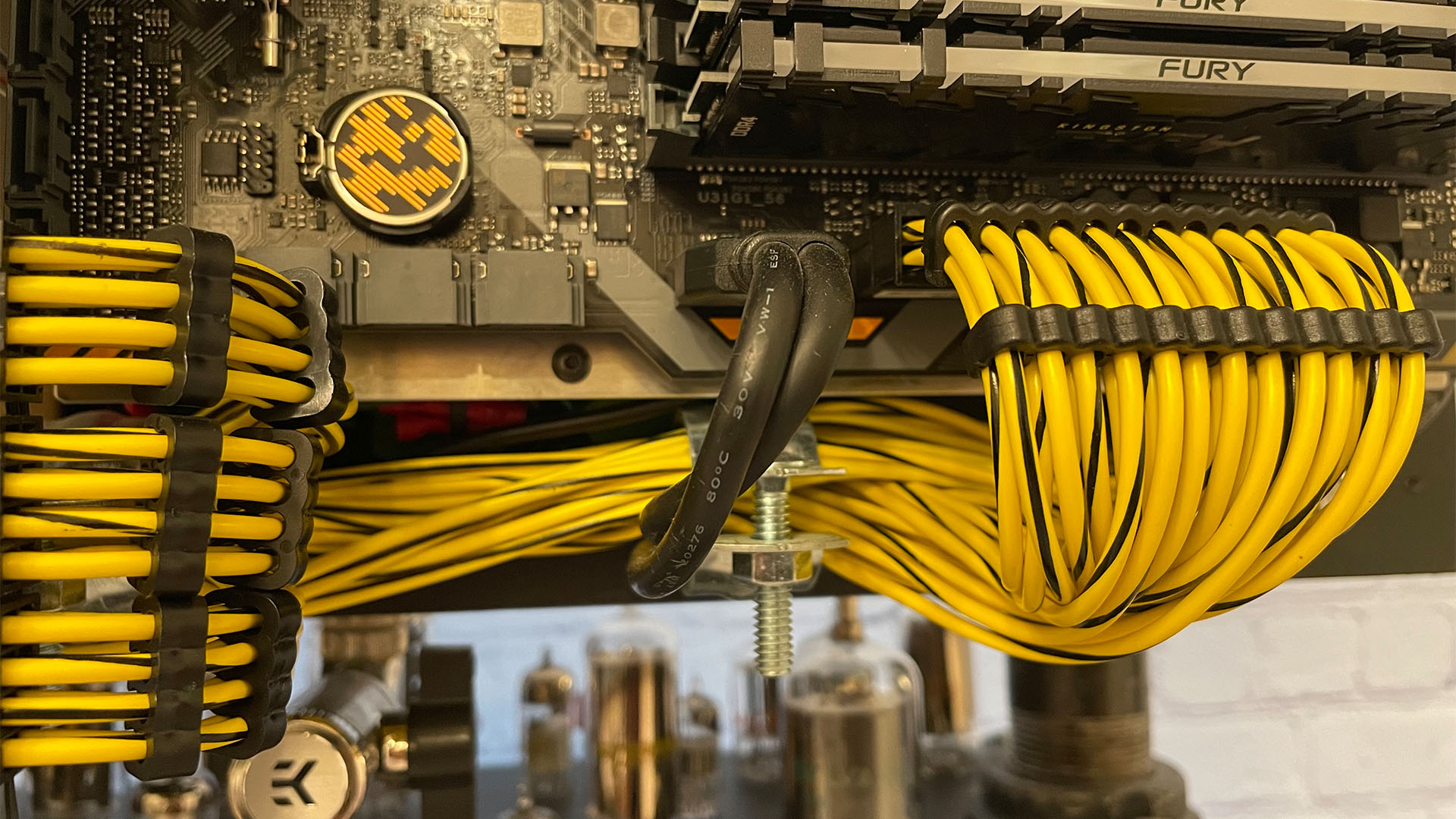 The yellow and black custom made cables on the steampunk gaming PC
