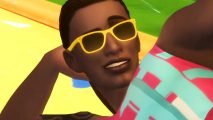 The Sims 4 Backyard Stuff is a free DLC on Steam and the EA store right now - A man wearing yellow sunglasses reclines with a smirk.