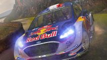 WRC 7 Steam sale: two people in a Red Bull rally car, with rain falling around them