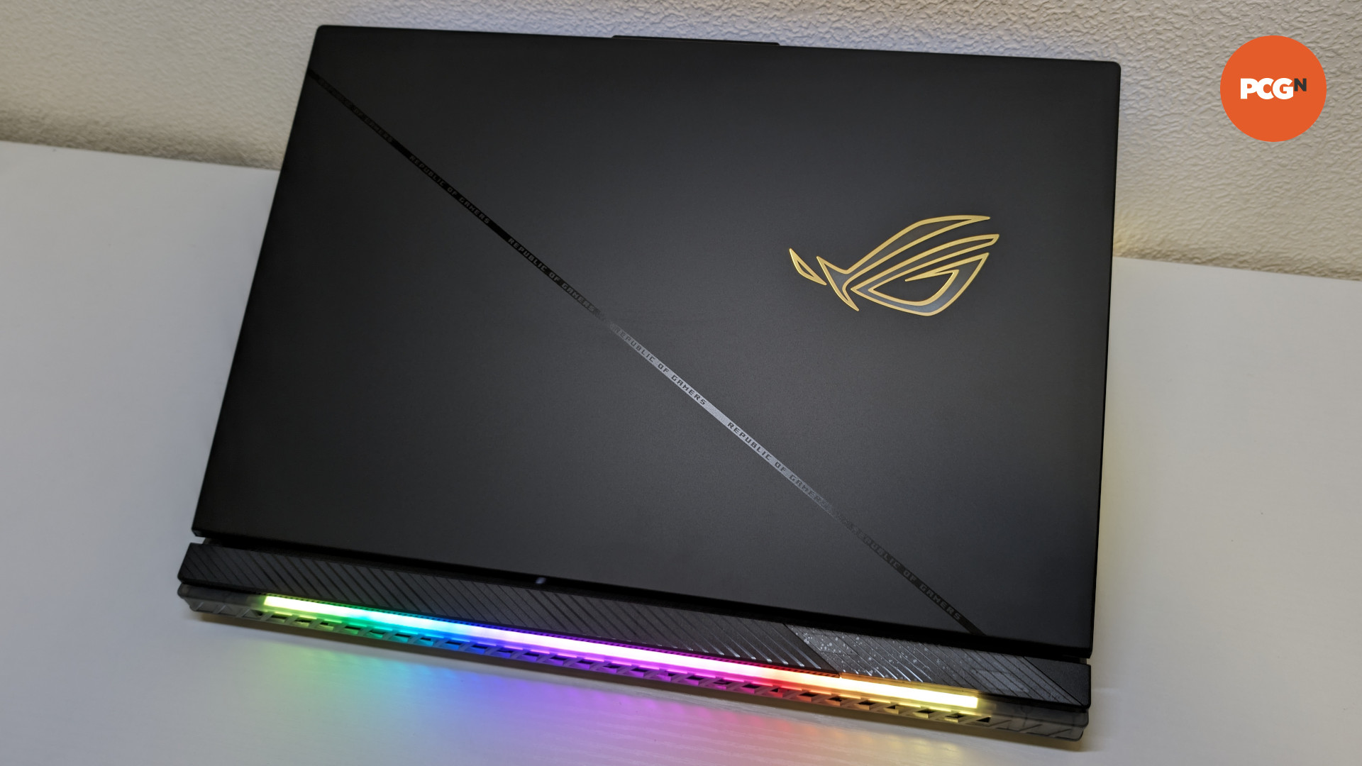 The lid of the ROG Strix Scar 18 (2024), showcasing its RGB logo (top right) and bar (bottom)