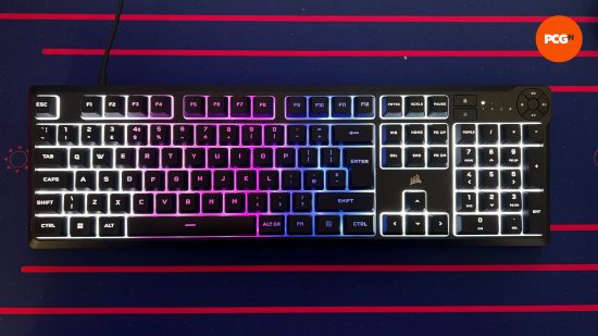A view of the corsair k55 from above while lit up and sitting on a purple and pink mouse mat