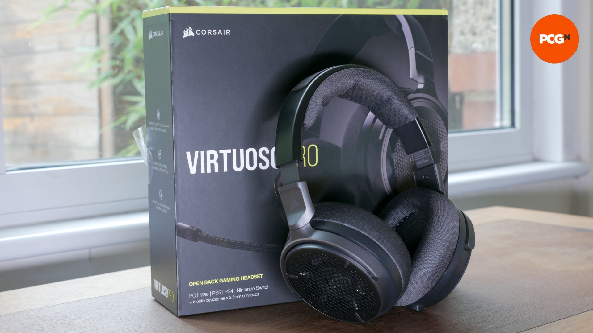 Corsair Virtuoso Pro review image showing the headset leaning against its box.