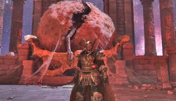 The Tarnished is standing next to a cocoon with a big arm sticking out of it, which is the Elden Ring Shadow of the Erdtree DLC start location.