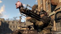 An Enclave character aims the piggy bank modded Fat Man up into the sky
