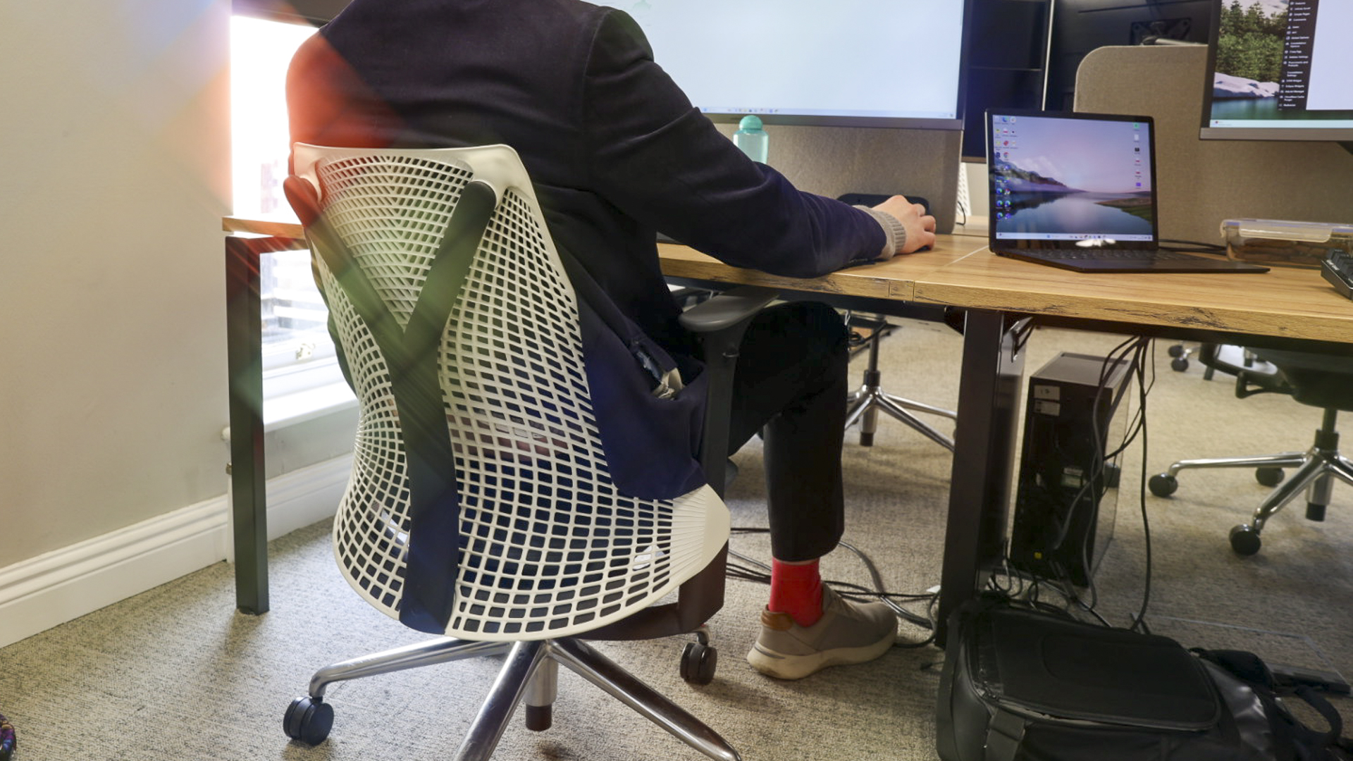 A person sitting in the Herman Miller Sayl office chair