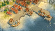 Get three legendary strategy games at a massive discount right now: An overhead view of an early modern village harborfront, from Anno 1404..