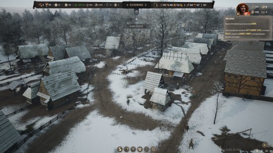 City building games: a birds eye view of a small medieval town, covered in snow.