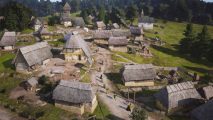 Manor Lords Steam milestone: an aerial shot of a medieval European village, with thatched roofs and a forest surrounding it