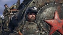 Grab this award-winning post-apocalyptic series for less than $10: Stepan from Metro Exodus stands in front of the game's train, looking out towards whatever the future holds.