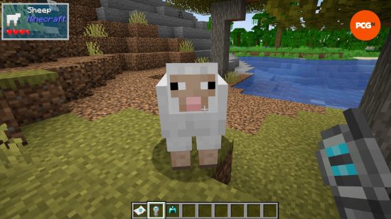 A player holding a probe looks at a sheep, a UI in the top corner shows the health state of the mob and other information thanks to one of the best Minecraft mods, The One Probe. 