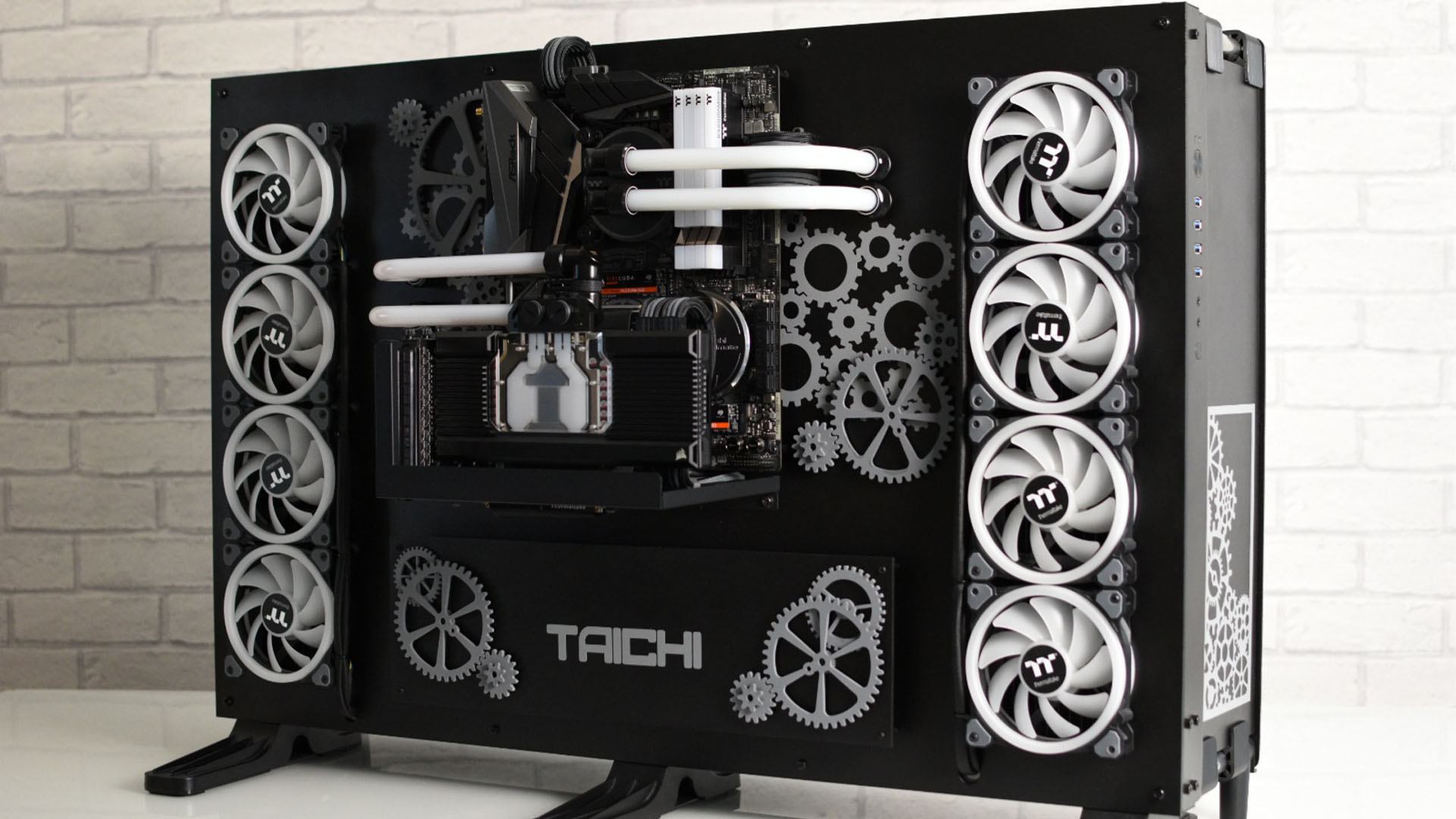 A black and white open air gaming PC build with cogs