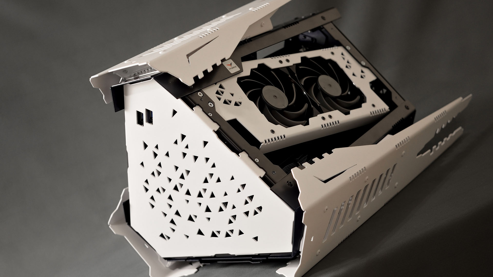 The white graphics card sitting inside the sputnik gaming pc case
