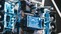 A wall mounted gaming PC with blue coolant