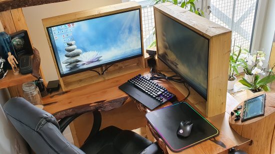 The wooden corner desk with two screens hidden by a wood panel