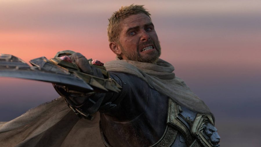 World of Warcraft: A blond, unkempt man grits his teeth, raising a broken sword at the camera as dusk falls behind him