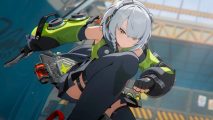 2024's most exciting anime game may just have a launch date, but there's a catch: A silver haired anime girl wearing a jumpsuit with long green gloves bends down towards the camera, ready for battle