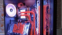 The red watercooled gaming PC with an angled graphics card and a dragon glass etching