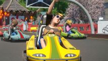 Legendary theme park sim shoots up Steam player charts due to big sale: A happy child in a go-cart cheers as he drives around a racetrack.