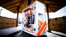 The orange and white Threadripper gaming PC on an outside table