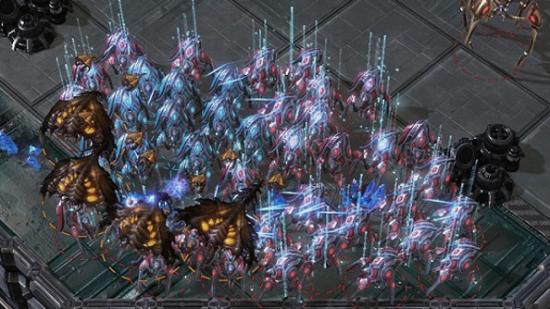 A group of spider-like Protoss Stalkers warp into existence beneath flying Brood Lords.